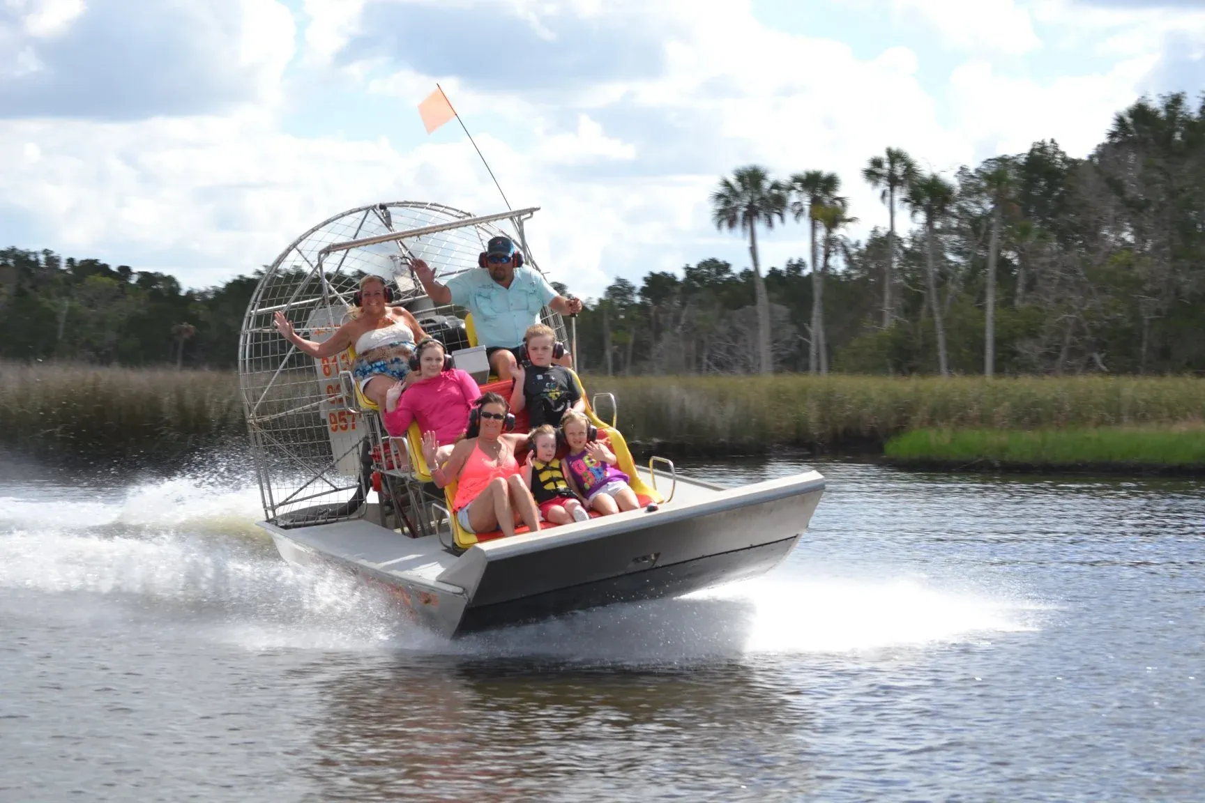 An airboat carries guests across Homosassa backwater with a captain at the helm.
